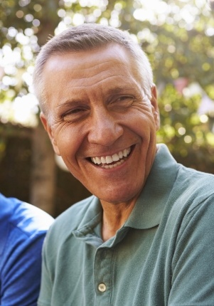 Man sharing healthy smile after full mouth reconstruction