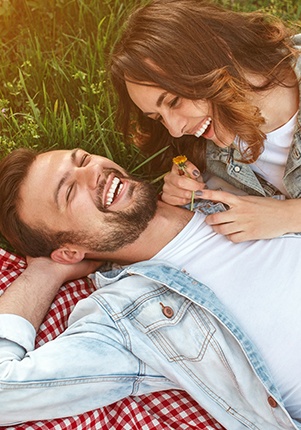 Man and woman with gorgeous smiles after smile makeovers