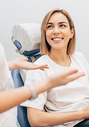 Dental patient and cosmetic dentist discussing the cost of smile makeovers