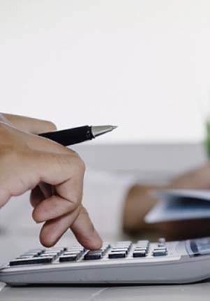 Man using calculator to determine cost of veneers in Mount Pleasant