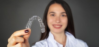 Woman sharing smile after Invisalign clear aligner treatment